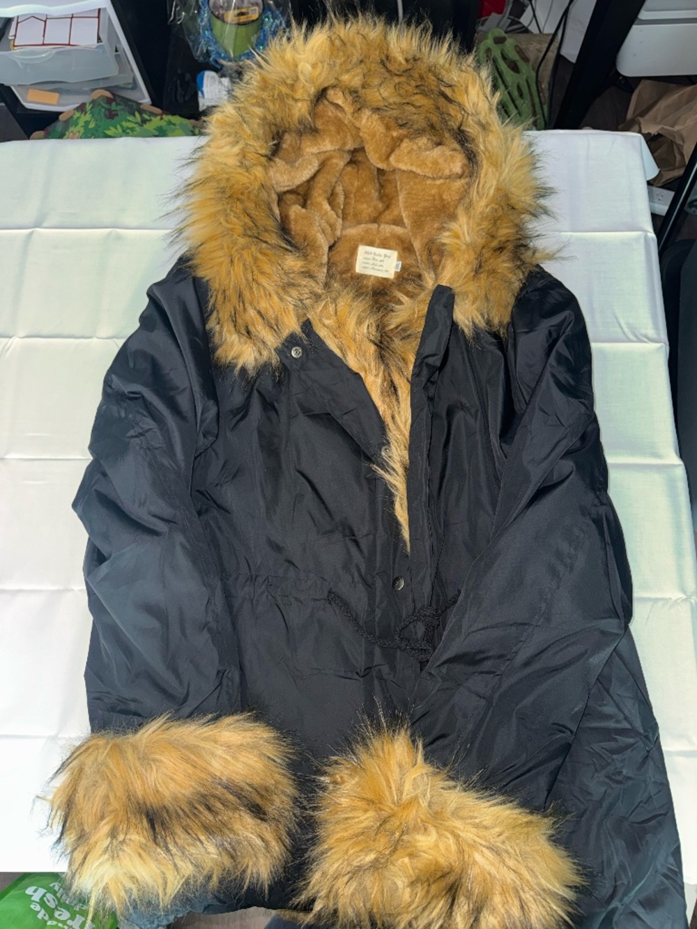 Tiptupu ASA Fashion Group black winter parka coat with tan faux fur trim